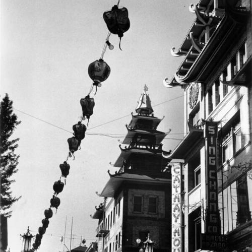 [Decorative lanterns draped from lamp posts on Grant Avenue in Chinatown]