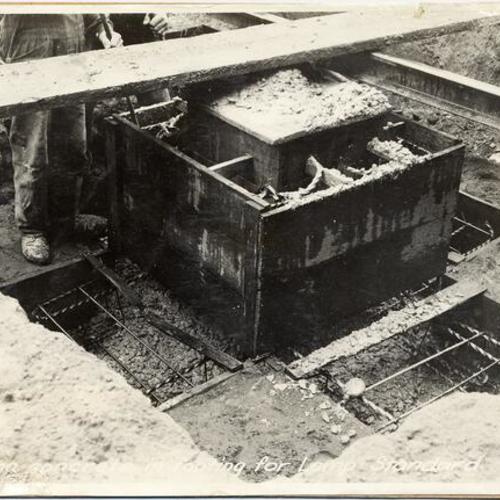 [Pouring concrete in footing for lamp standard at the Panama-Pacific International Exposition]