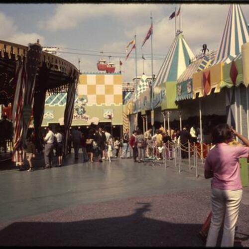 People at Mad Hatter and Peter Pan attraction