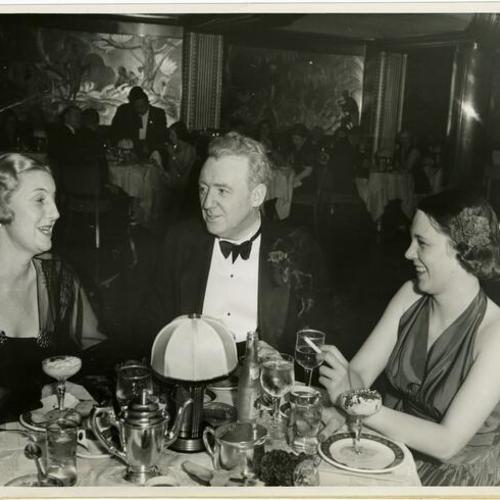 [Mrs. August W. Virden, Dr. Thomas W. Connolly and Miss Irma K. Luce in the Persian Room of the Hotel Sir Francis Drake]