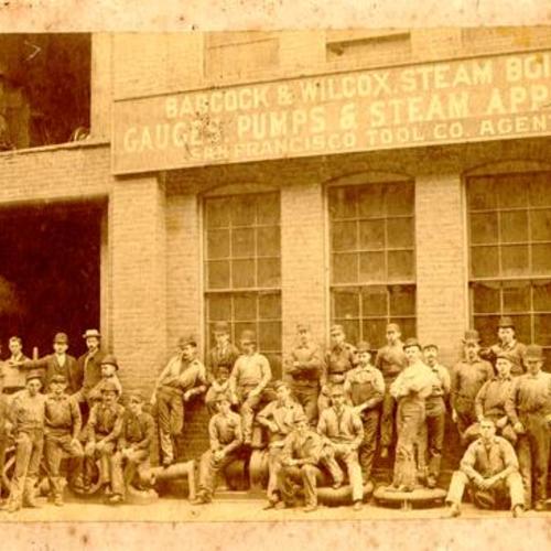 [Group of male employees posing for a photograph outside of the Babcock and Wilcox building]