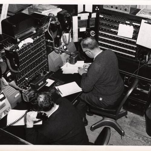 [Employees working at the Communications Room in Old Hall of Justice]
