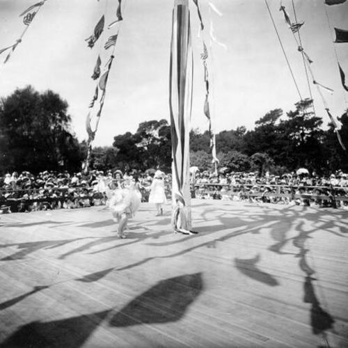 [Performers on stage during a May Day celebration in Golden Gate Park]
