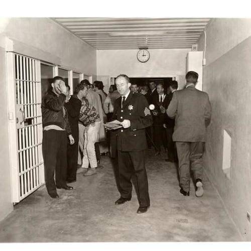 [Sergeant Piboni[?] with detainees in Old Hall of Justice]