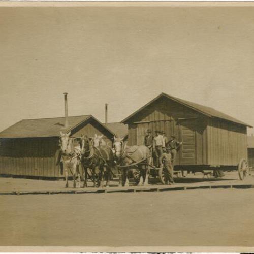 [Men and horses moving a cottage after the 1906 earthquake and fire]