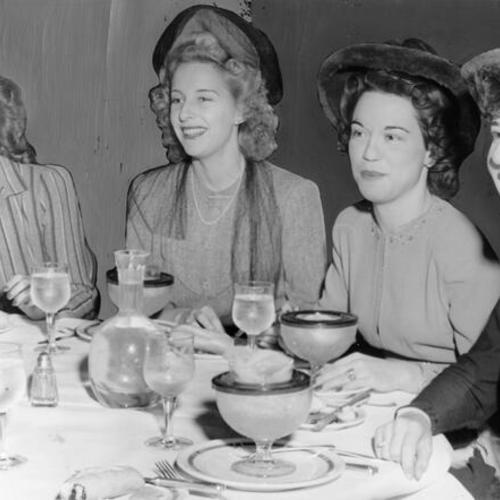 [Mrs. Frank Spreckels, Nancy Heywood, Petite Crowell and Mrs. A. H. Markwart at a luncheon at the St. Francis Hotel]