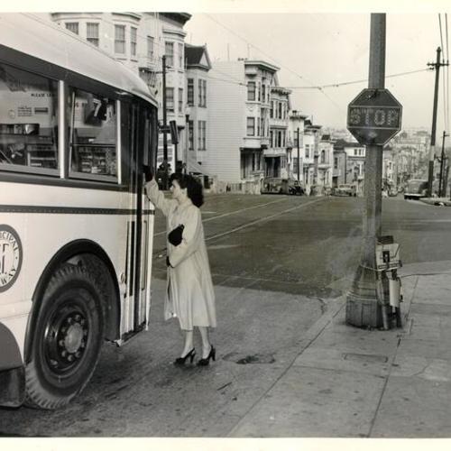 [Woman attempting to board a Muni bus at the intersection of Haight and Divisadero streets]
