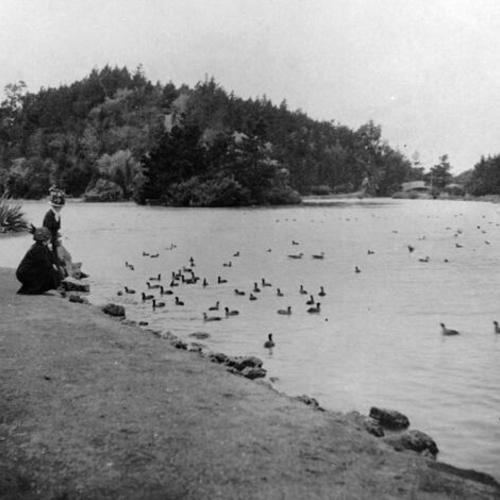 [Two women on the shore of Stow Lake in Golden Gate Park]
