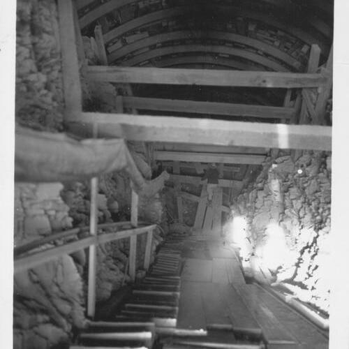 [View looking down into south anchorage tunnel on Yerba Buena Island during San Francisco-Oakland Bay Bridge construction]