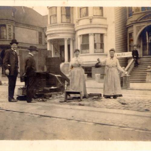 [People cooking at street kitchen on an unidentified street]