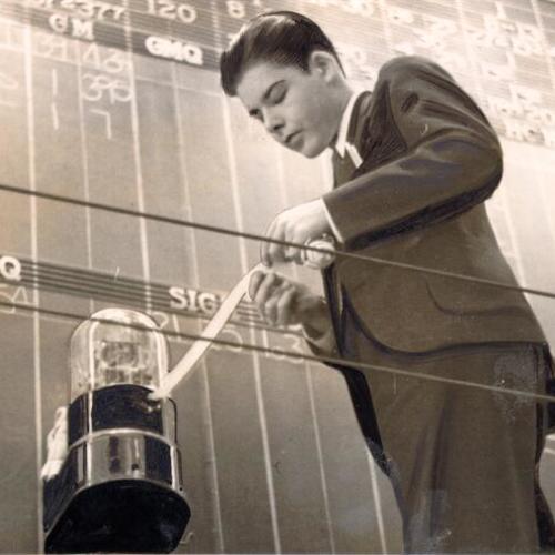 [Brokerage house employee reading stock prices off an exchange ticker at the San Francisco Stock Exchange]