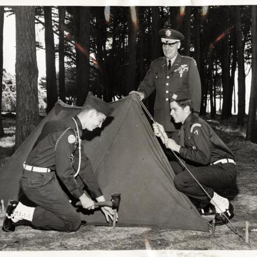 [Explorer Scouts Tom Burke and Burke Pease demonstrating tent pitching with Colonel Charles G. Rau during the first Annual Explorer Bivouac]