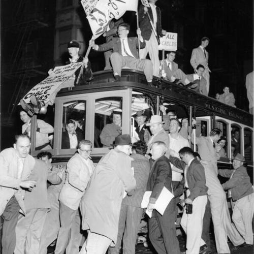 [Crowd of people protesting the replacement of Hyde Street cable cars with buses]