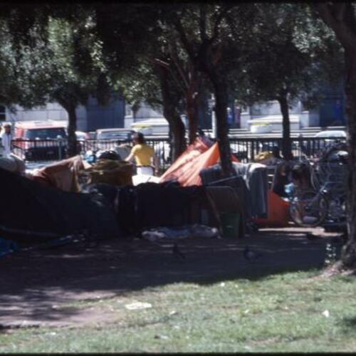 [People amongst tents and other personal belongings at Civic Center]