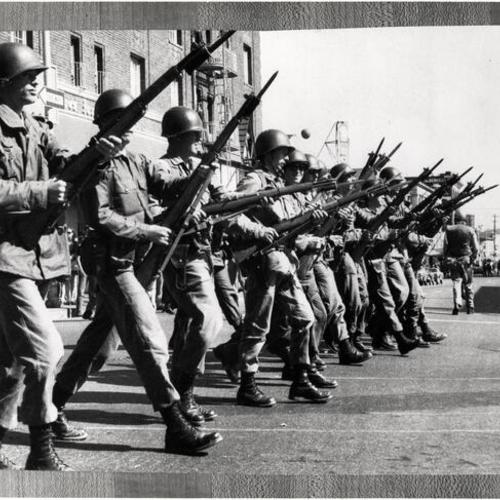 [National Guardsmen marching through Berkeley street near University of California campus]