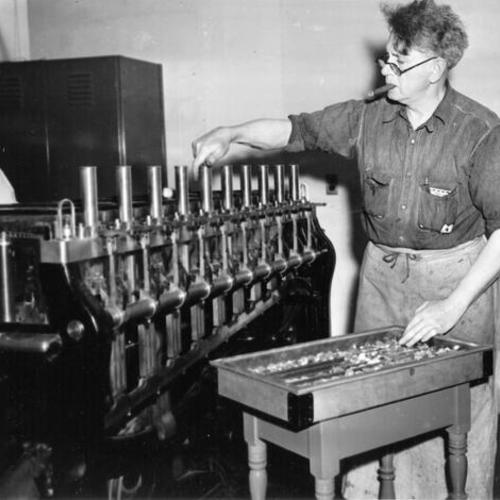 [Jim Donovan operating weighing machinery at the U. S. Mint in San Francisco]