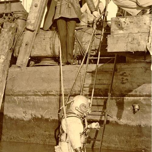 [Golden Gate Bridge construction diver J. A. Johnson is lowered into Bay]
