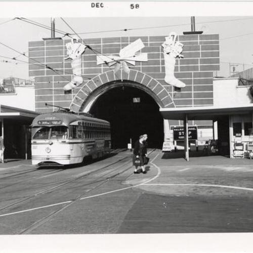 [West Portal Twin Peaks Tunnel decorated as Christmas fireplace with outbound Muni "K" line car 1027]