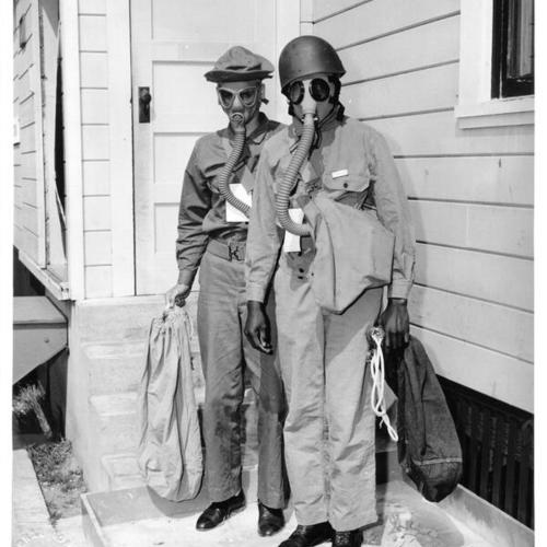 [Two men wearing gas masks during a casualty drill at Letterman General Hospital]