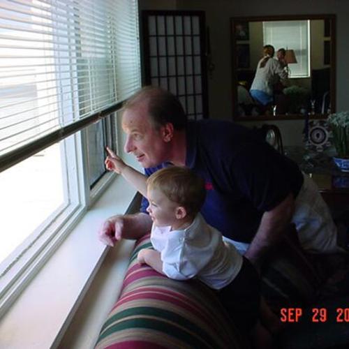 [A man with his grandson, Joey, looking out of apartment window]