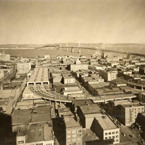 [View of transbay terminal at First and Mission streets, looking east with Treasure Island, Yerba Buena Island and the San Francisco-Oakland Bay Bridge in background]
