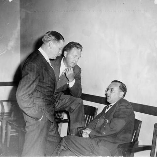 [District Attorney Edmund G. Brown (right) with L. R. Norman (left) and Marshall Leahy]