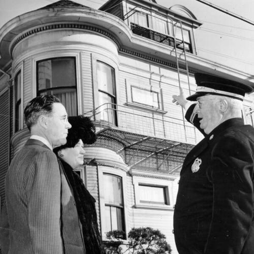 [Fire Commissioner James J. Sullivan (left), Mrs. Theodore G. Swanson and Assistant Fire Chief Martin J. Kearns discussing progress of campaign to replace old Florence Crittenton home]