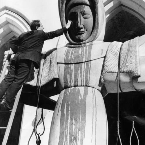 [Sculptor Beniamino Bufano with his Statue of Saint Francis of Assisi as it was being prepared to be moved from the entrance of the St. Francis Church to a temporary location in Oakland]