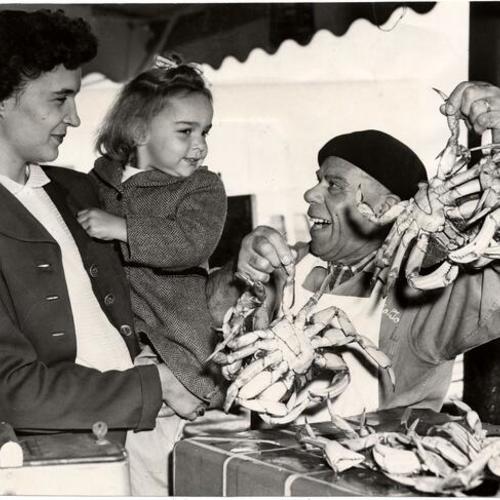 [Sam Alioto giving Marilyn Cope her choice of two fresh crabs at Fisherman's Wharf]