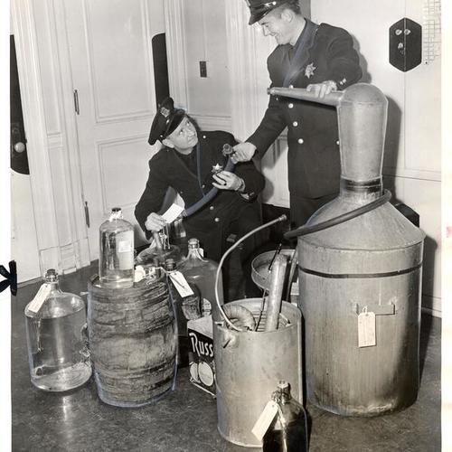 [Police Officers John McQuaide and James Cannon taking inventory of the illicit home distillery of Albert Liberati Bruno]