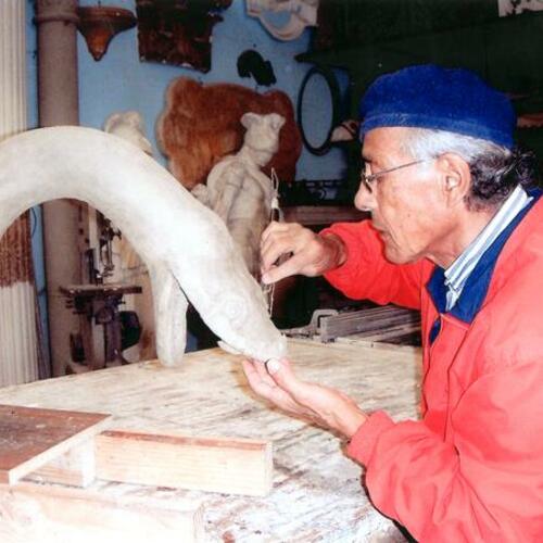 [Manuel Palos in his studio sculpting serpent's head for the fountain at the Golden Gate Music Concourse]