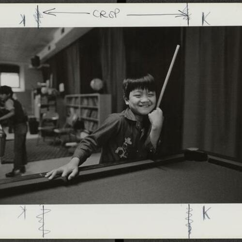 Child at pool table in the Tenderloin Recreational Center