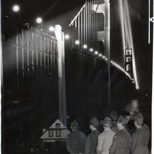 [Golden Gate Bridge at night, with special lights for its 10th anniversary]