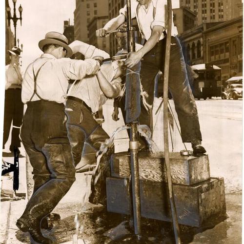 [WPA workmen drilling the pavement to determine foundation structure for San Francisco's subway system]