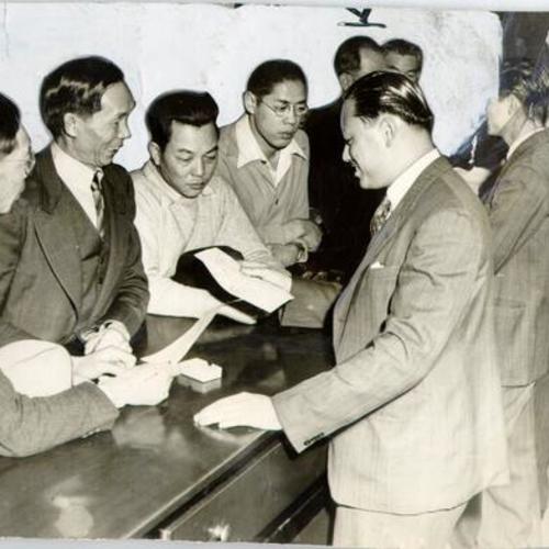 [Group of men registering at the Chinese consulate generals office in Chinatown]