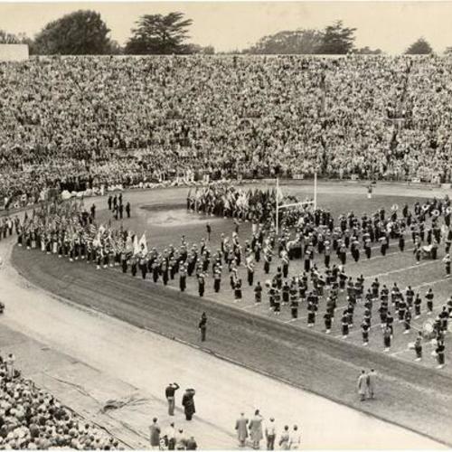 [Marching band playing the national anthem before an East-West Shrine football game at Kezar Stadium]