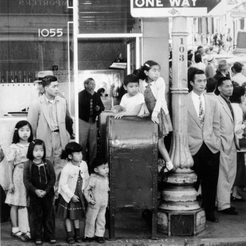 [People watching the funeral procession for Albert Chow in Chinatown]