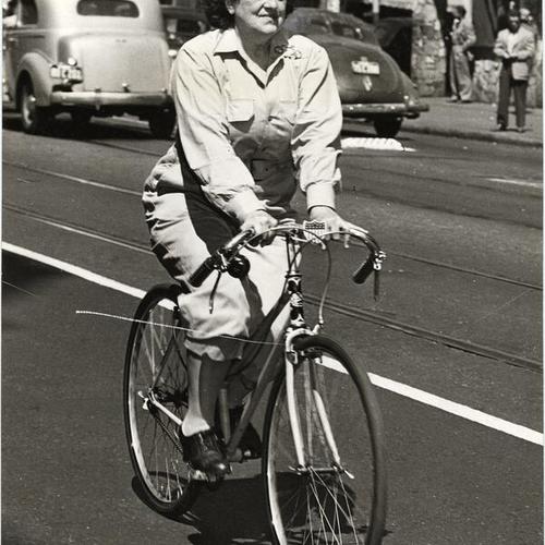 [Mrs. Louis Fitzgerald riding a bicycle during streetcar strike]
