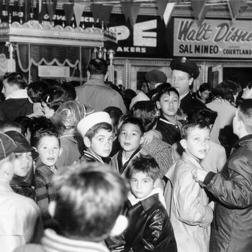 [Crowd of kids wait to get into the Fox theater]