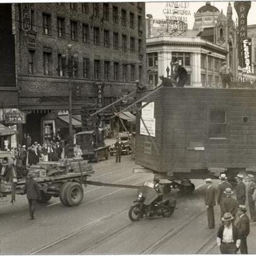 [Small building being moved down Market Street]