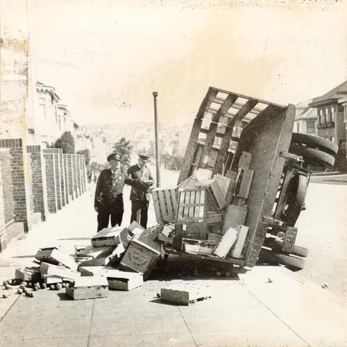 [Police officers examining the overturned truck during the teamster sympathy strike]