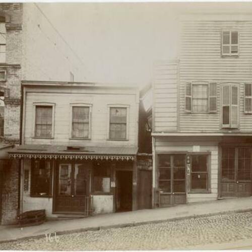 165 Street with storefronts for grooming and furniture repair