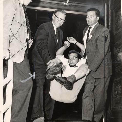 [Deputy Marshals James Comerford and Alex Koening carrying a young man out of Post Office building]
