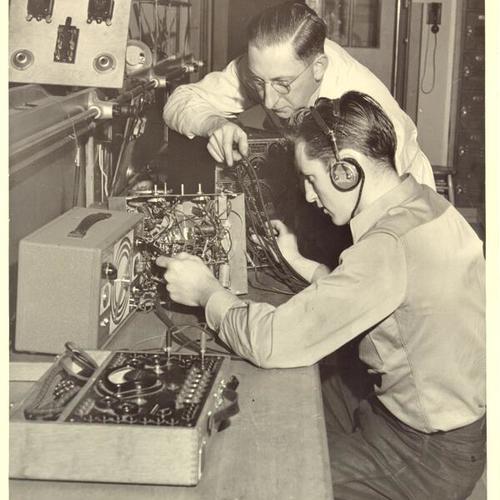 [Leonard Grady and Instructor Rex Harris servicing radios at James Denman Junior High School]