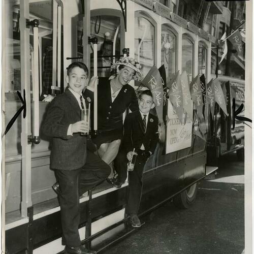 Mrs. Robert Roos, Jr. and sons, Page and Billy, on cable car