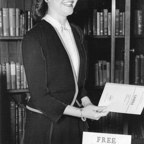 [Ruth Brogger, Library Assistant, distributing pamphlets in Art Department during United Nations Conference taking place in Main Library]