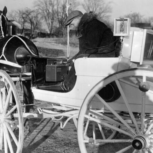 [Frank Dyer on his horse drawn vehicle equipped with lights, radio and loudspeakers]