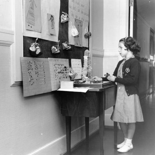 [Student looking at a Girl Scout display at Gough School for the Deaf, 1945 Washington Street]