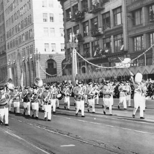 [Marching band passing by spectators in the opening day celebration parade for San Francisco-Oakland Bay Bridge]