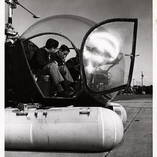 [Scout Ramon Disperati, explorer Barton Carpenter, and Capt. Leslie Gilbert checking out a helicopter at Crissy Field]
